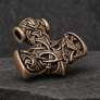 Bronze Thor’s Hammer pendant in side profile with detailed wolf and raven ornament