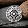 Hail Odin Sterling Silver ring on a rocky surface