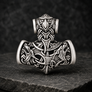 Front view of silvered bronze Viking Mjolnir pendant with wolf, raven and Norse knotwork details