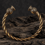 Scottish Thistle bronze bracelet in premium dark studio setting on rugged wood