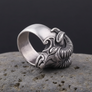 Silvered ram head ring on a rocky surface