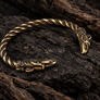 Close-up detail of Thunderbird bronze armring terminal showing bird-inspired design