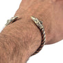 Thunderbird bronze armring worn on wrist showing fit and myth-inspired twisted design