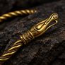 Close-up of Viking Urnes dragon head terminal on brass armring