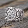 Silvered Bronze Viking Ring With Vegvisir and Jormungandr on a rocky surface