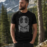 Men’s Born of Thunder Mjolnir Viking t-shirt front print worn by a bearded man in a Scandinavian mountain landscape