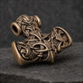 Bronze Thor’s Hammer pendant in side profile with detailed wolf and raven ornament