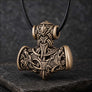 Bronze Viking Mjolnir pendant with wolf and raven motifs on dark stone