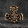 Back view of bronze Thor’s Hammer pendant with Norse knotwork and animal detailing