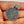 Silver Replica pendant with intricate design held in a hand