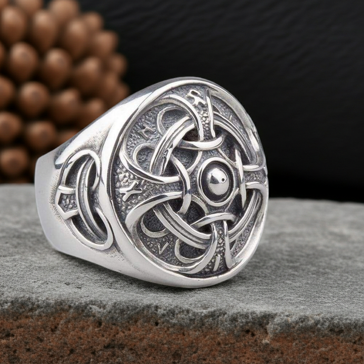 Hail Odin Sterling Silver ring on a rocky surface