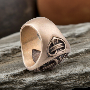 Hail Odin Bronze ring with intricate design on a wooden surface