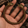 Collach Pictish Boar bronze bracelet shown in hand for size and detail