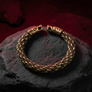 Bronze braided bracelet Gotland on a rocky surface
