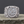 Silvered Bronze Viking Ring With Vegvisir and Jormungandr on a rocky surface