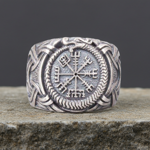 Silvered Bronze Viking Ring With Vegvisir and Jormungandr on a rocky surface