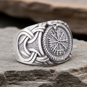 Silvered Bronze Viking Ring With Vegvisir and Jormungandr on a rocky surface