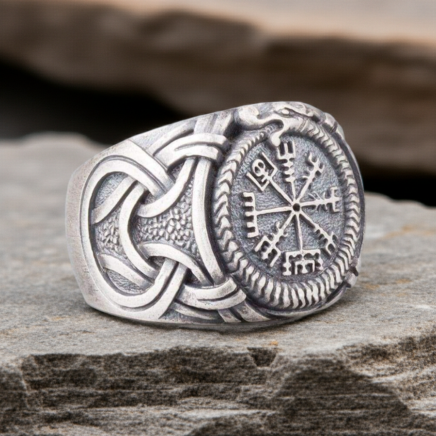 Silvered Bronze Viking Ring With Vegvisir and Jormungandr on a rocky surface