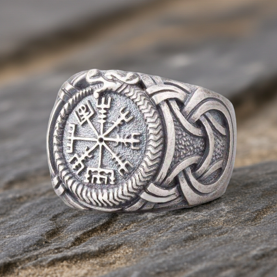 Silvered Bronze Viking Ring With Vegvisir and Jormungandr on a rocky surface