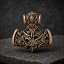Front view of bronze Thor’s Hammer pendant with Norse knotwork and animal detailing