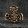 Back view of bronze Thor’s Hammer pendant with Norse knotwork and animal detailing