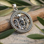 Close-up detail of Hecate 925 sterling silver pendant showing three faces and triple moon relief engraving