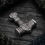 Angled view of 925 sterling silver Thor’s Hammer pendant showing serpent relief and textured handle