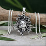 Medusa sterling silver pendant flat lay with wheat chain and olive leaves, ancient Greek Gorgoneion amulet