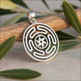 Close-up detail of Wheel of Hecate 925 sterling silver pendant showing intricate labyrinth spiral and six-pointed star center